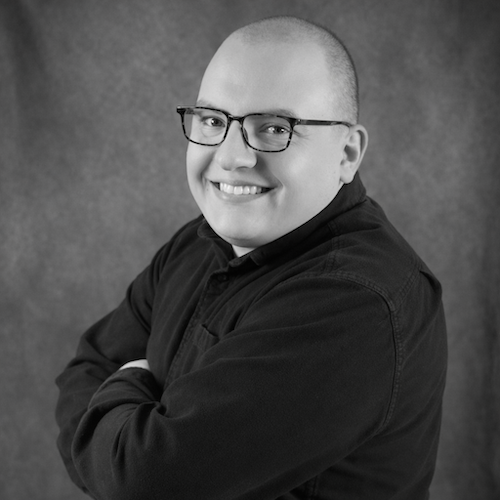 Brandon Younie, a landscape designer for Harmony Design Group smiles at the camera.