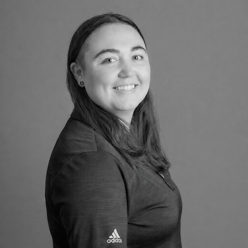 Young woman with dark hair, smiling. Kerri Jewell at Harmony Design Group.